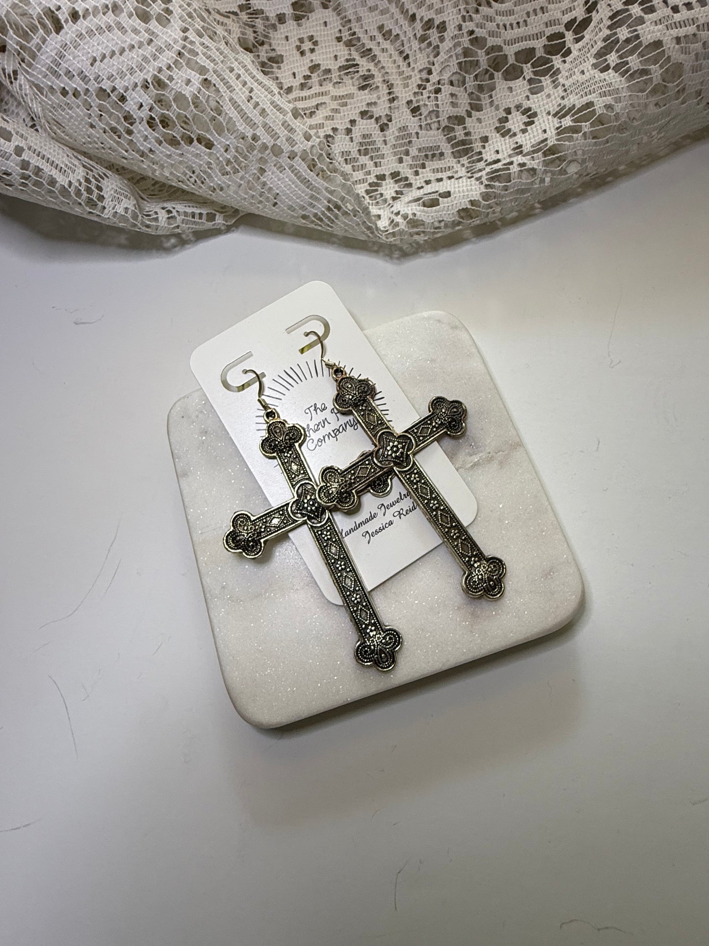 Cross statement earrings