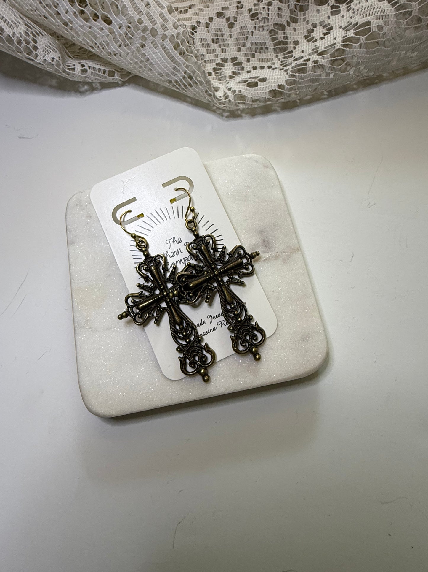 Cross statement earrings